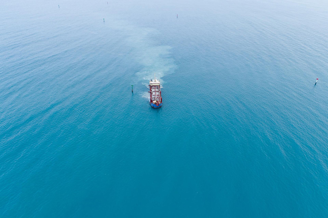 Aerial view of ship in ocean.