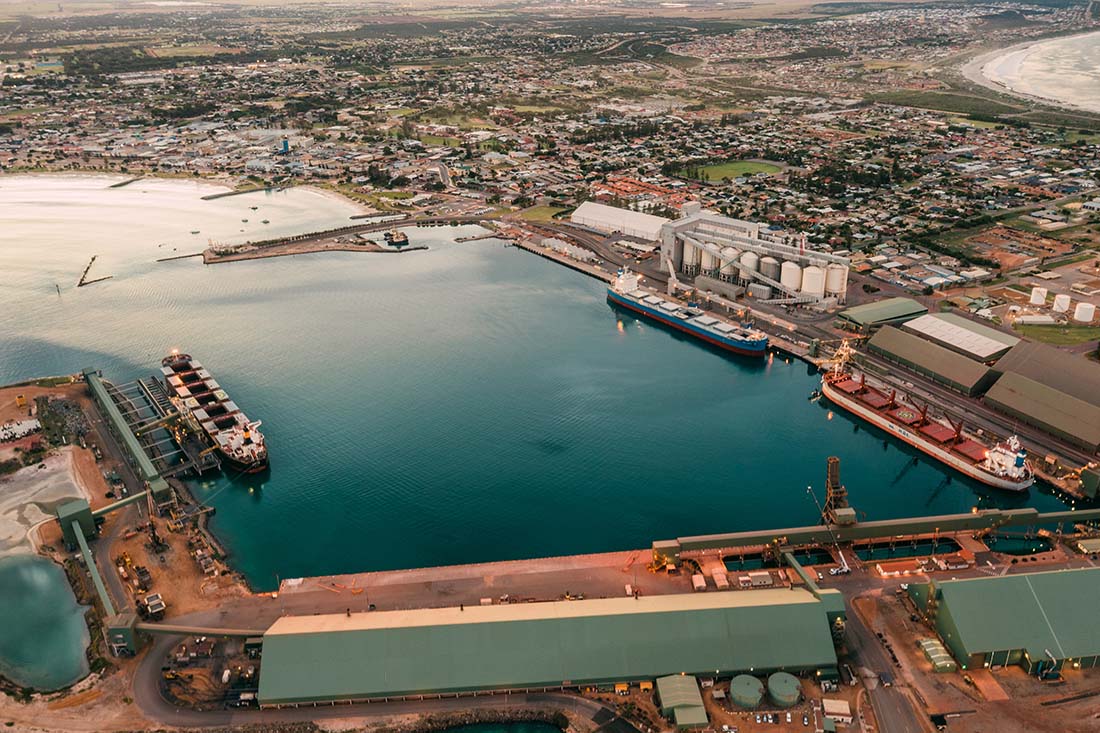 Aerial view of port at bottom with view of Geraldton city in winter above
